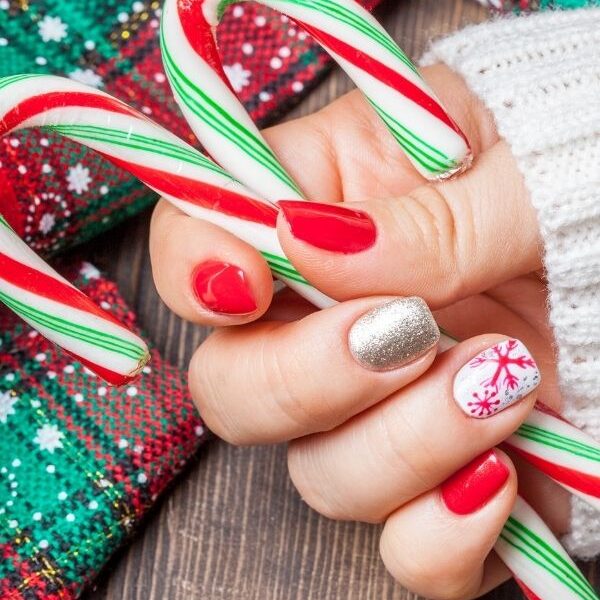 Christmas-nail-designs-close-up-of-a-womans-hands-festive-holiday-background-in-christmas-nail-ideas-featured-image