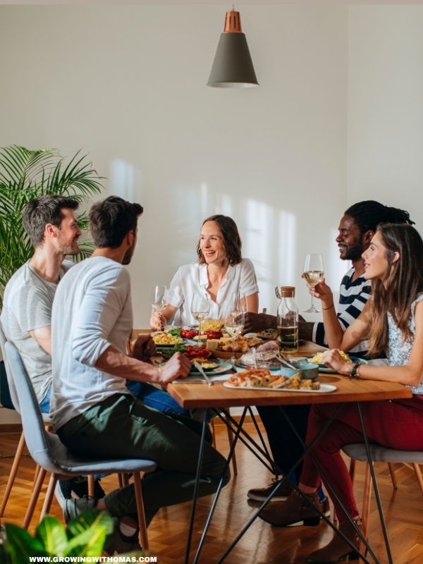 friends-sitting-around-a-table-enjoying-a-meal