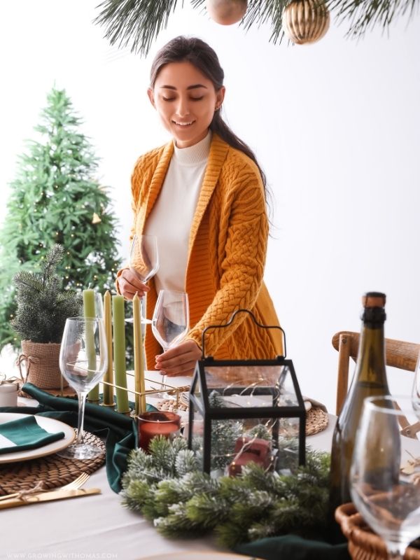 Woman-happily-hosting-a-beautiful-Christmas-dinner-at-home-in-christmas-hosting-ideas