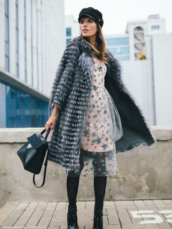 Woman-wearing-a-cozy-cream-knit-midi-dress-with-ankle-boots-and-a-winter-coat