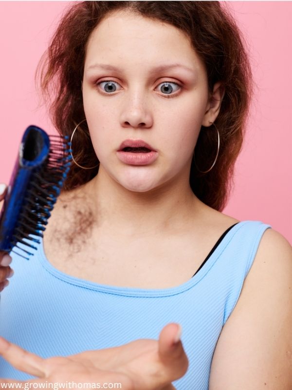 image-of-a-woman-hair-breaking-while-combing