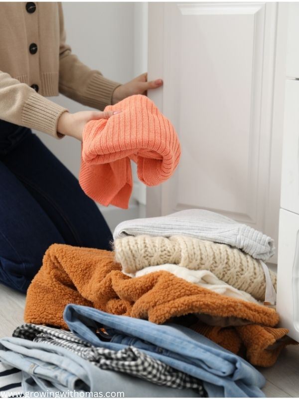 woman-decluttering-her-clothes