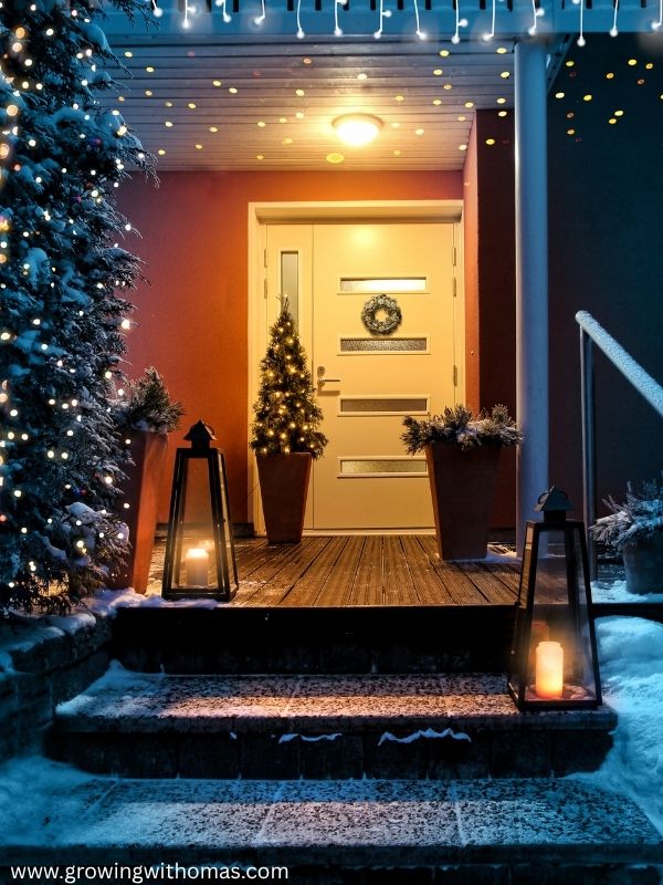 A-Christmas-entryway-decorated-with-a-wreath-small-tree-basket-and-warm-holiday-accent