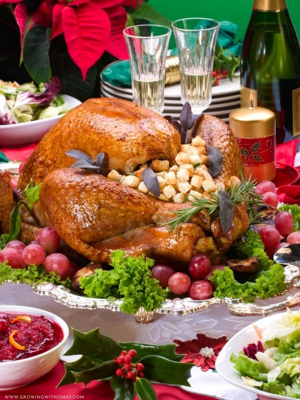 beautiful-Christmas-dinner-table-with-glazed-ham-mashed-potatoes-roasted-vegetables-dinner-rolls-and-festive-decorations.-featured-image-in-christmas-food-ideas