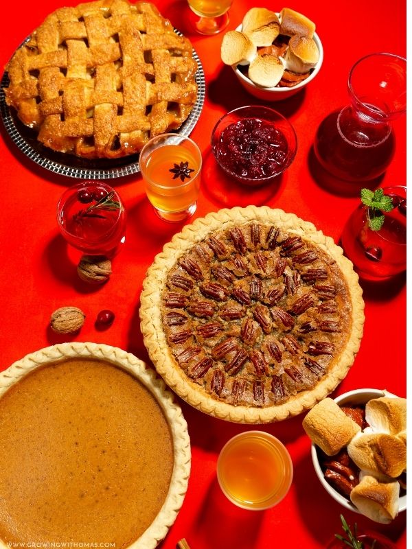 Beautiful-Thanksgiving-dessert-table-with-pumpkin-pie-pecan-pie-cupcakes-cookies-and-fall-decorations-featured-image-thanksgiving-dessert-ideas