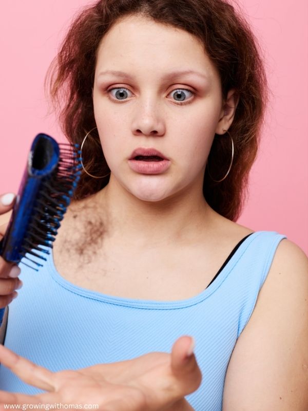 a-woman-holding-her-strands-of-hair-from-breakage