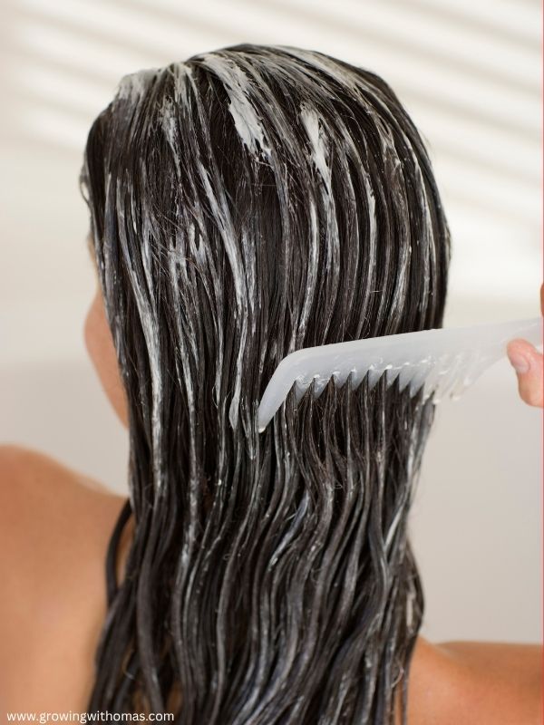 woman-applying-conditioner-on-her-hair